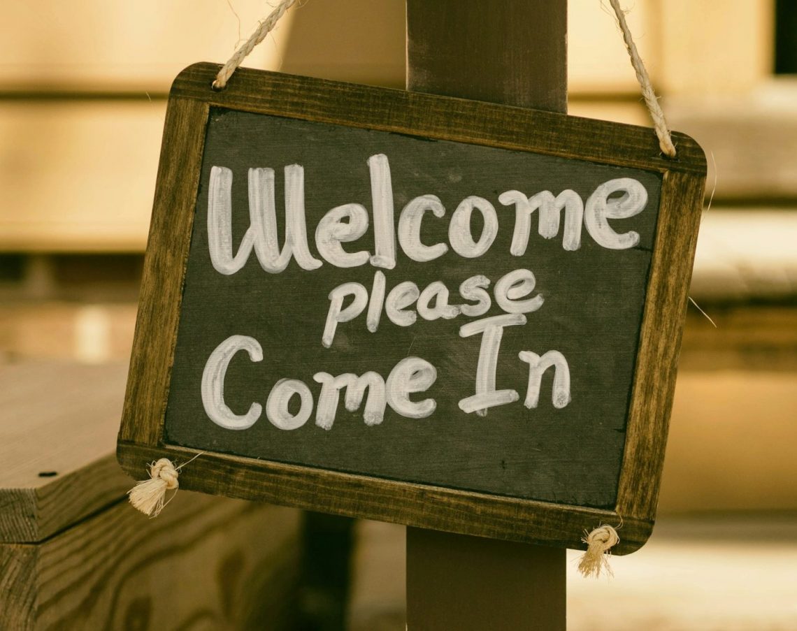 A sign, saying 'Welcome. Please come in'.