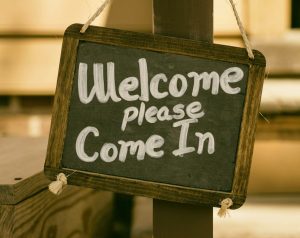 A sign, saying 'Welcome. Please come in'.