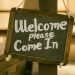 A sign, saying 'Welcome. Please come in'.