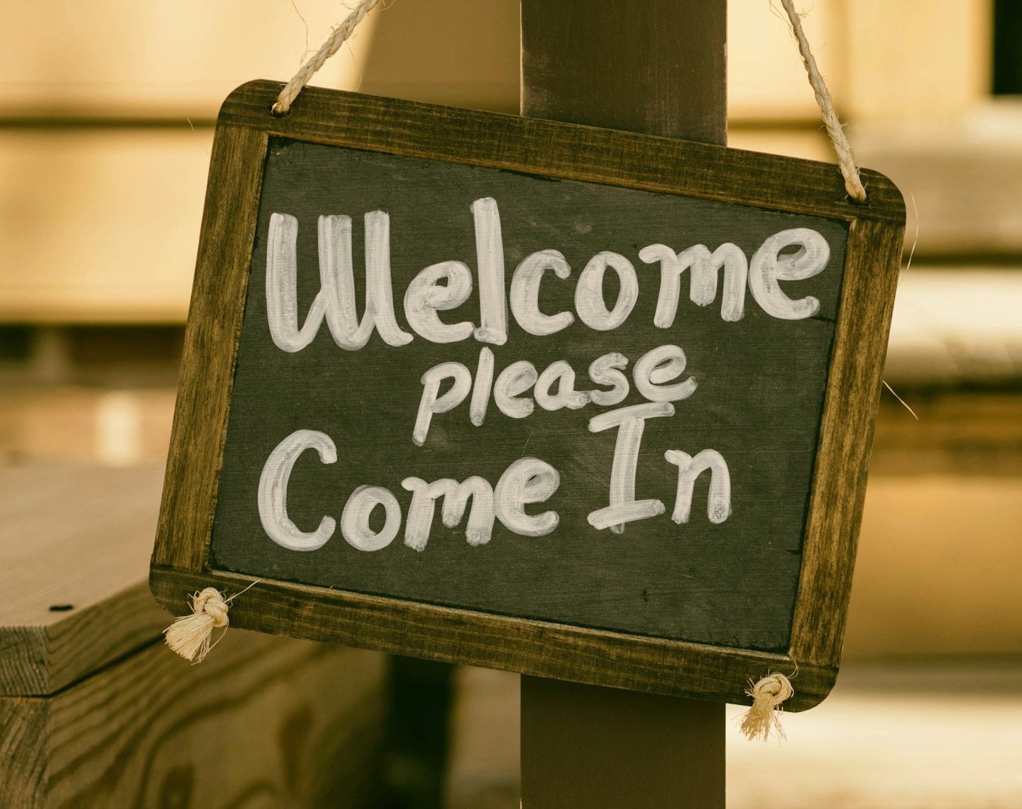 A sign, saying 'Welcome. Please come in'.