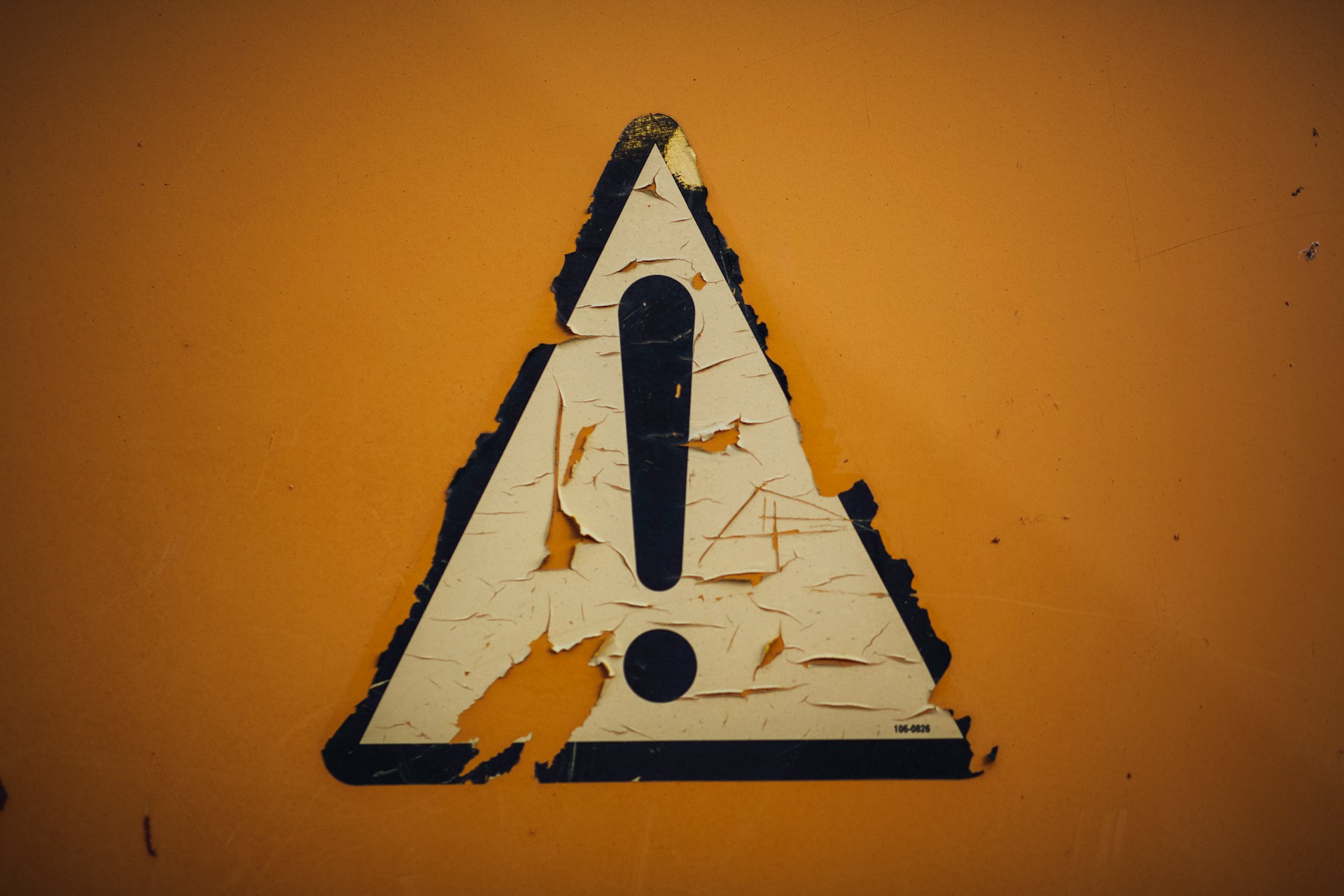 Rusty metal iron weathered sticker "caution" ! by Markus Spiske