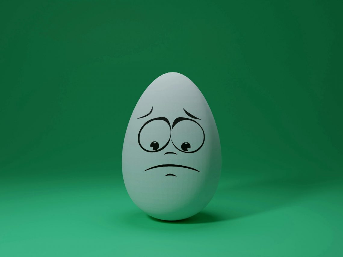 Title Image for article: Reacting to OCD Thoughts (part 1). An egg with a sad face drawn on it. By Shubham Dhage